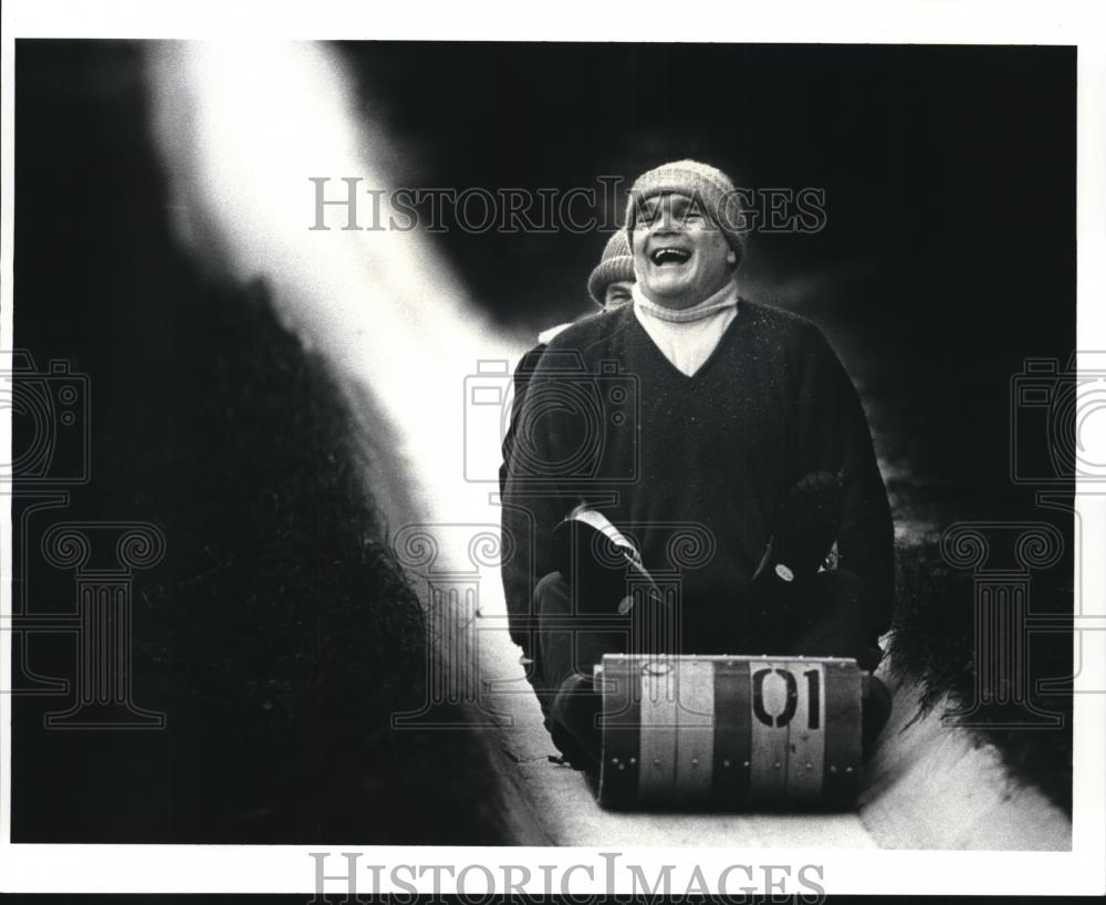 1987 Press Photo Norbert S. Briggs enjoys himself on the tobaggan run - Historic Images