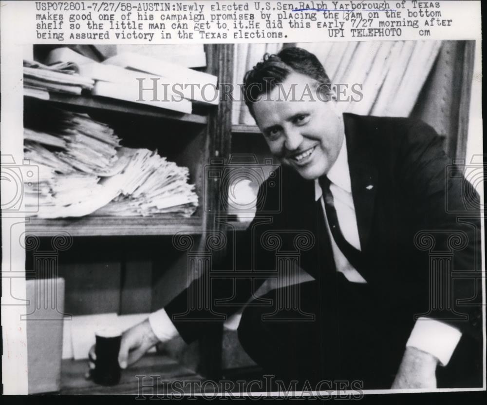 1958 Press Photo Sen Ralph Yarborough Putting Jam on Bottom Shelf in Austin TX - Historic Images