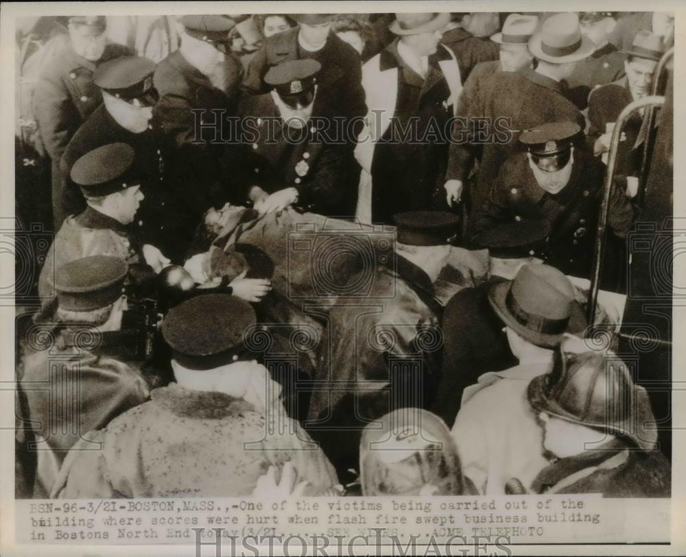 1947 Press Photo Victim Carried from Scene of Fire in Boston North End - Historic Images