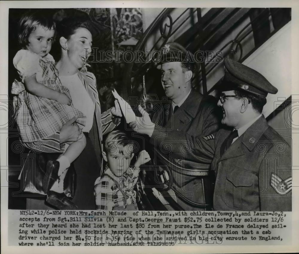 1951 Press Photo Mrs. Sarah McDade and children accept money from Soldiers. - Historic Images