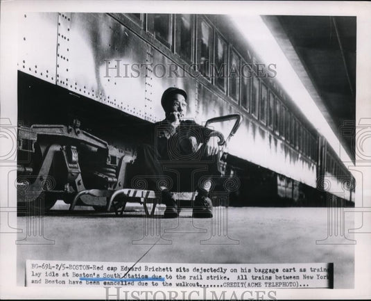 1951 Press Photo Edward Brichett on Baggage Cart in Boston's South Station - Historic Images