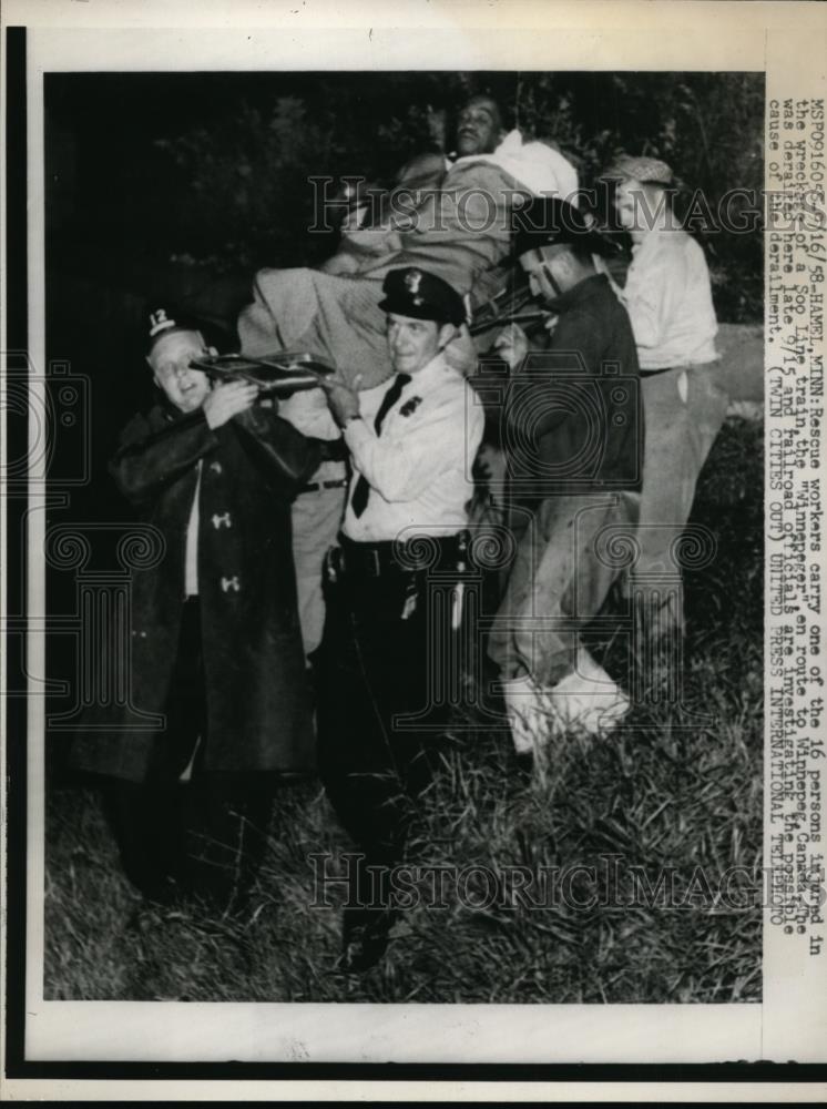 1958 Press Photo Rescue Workers Carried Injured Soo Line Train Wreck Passenger - Historic Images