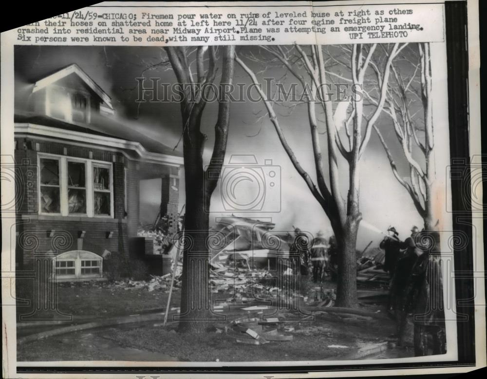 1959 Press Photo Chicago Firemen poor water on ruins of leveled house. - Historic Images