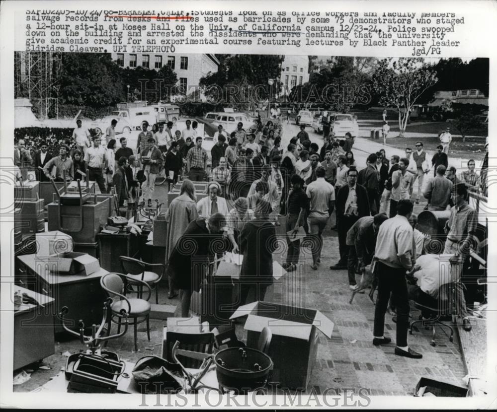 1968 Press Photo Univ. of Calif. student and workers salvage records form desk. - Historic Images