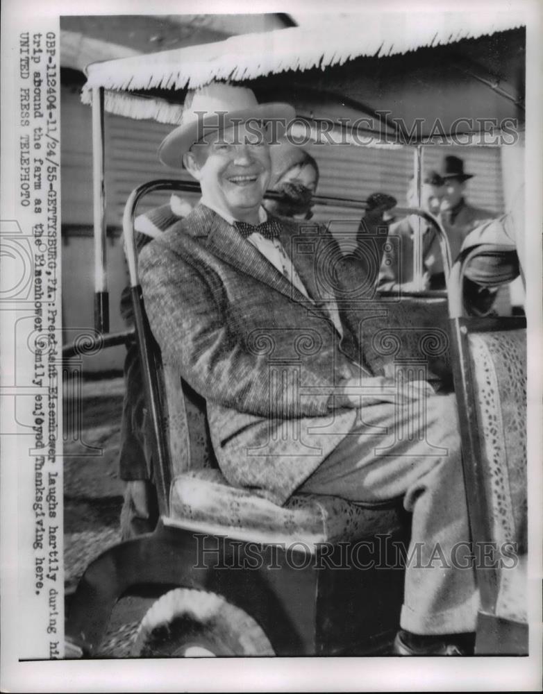 1955 Press Photo Pres.Eisenhower laughs during his trip around his Farm. - Historic Images