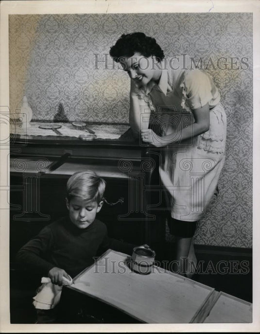 1951 Press Photo A boy waxes a bureau drawer as his mom watches - nee87431 - Historic Images