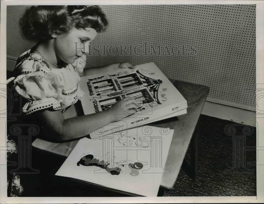 1953 Press Photo A young girl coloring in some coloring books - nee85492 - Historic Images