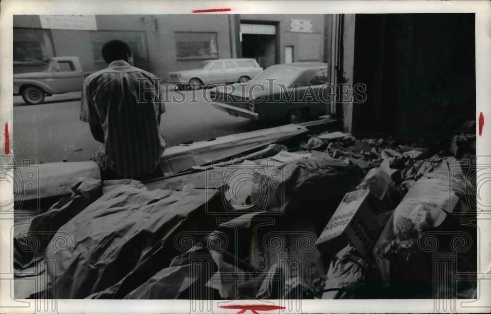 1972 Press Photo Jud Lombard relaxes in front of piled trash in Cleveland Ohio - Historic Images