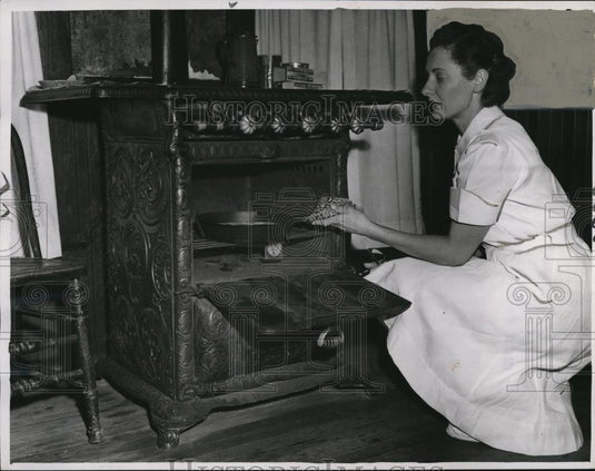 1949 Press Photo Nurse Wilma Apary with the old stove - cva72265 - Historic Images