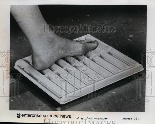 Press Photo A foot massager demonstrated on a mans foot - nee86761 - Historic Images