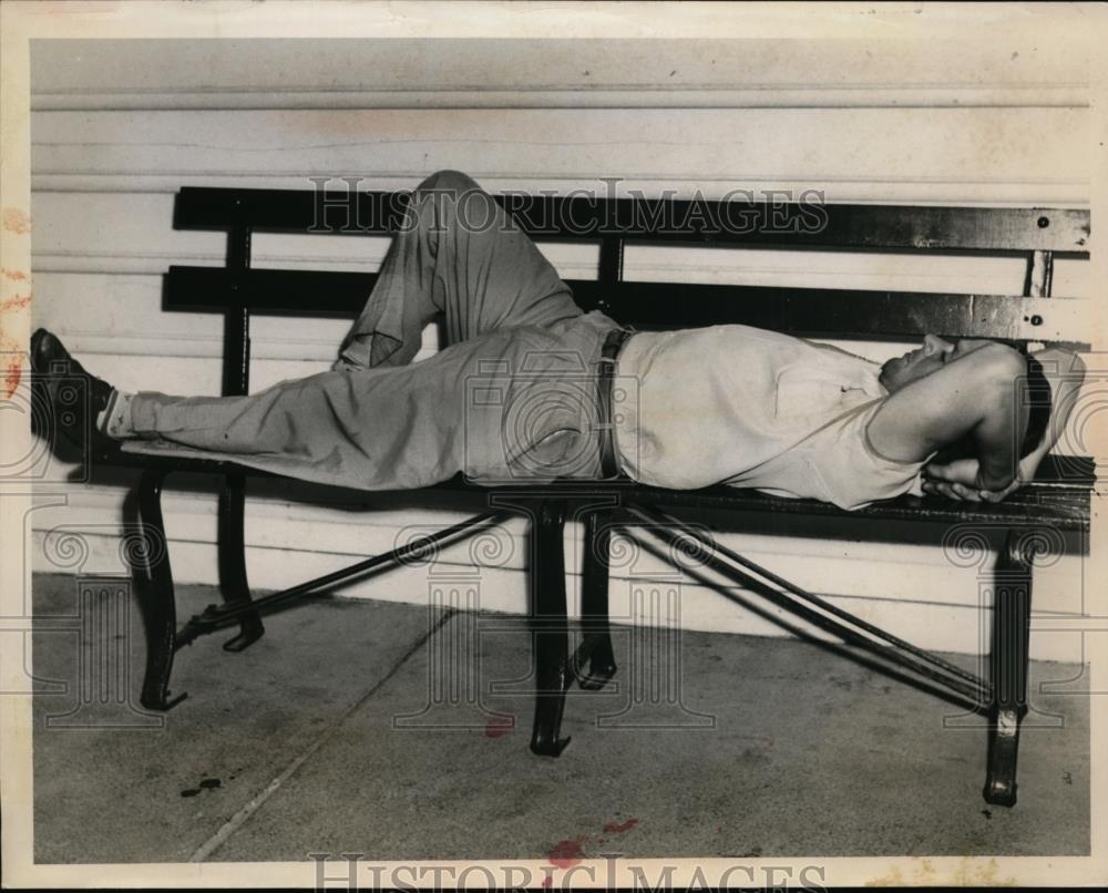 1957 Press Photo Thomas Marotta laying on a bench - nee86944 - Historic Images