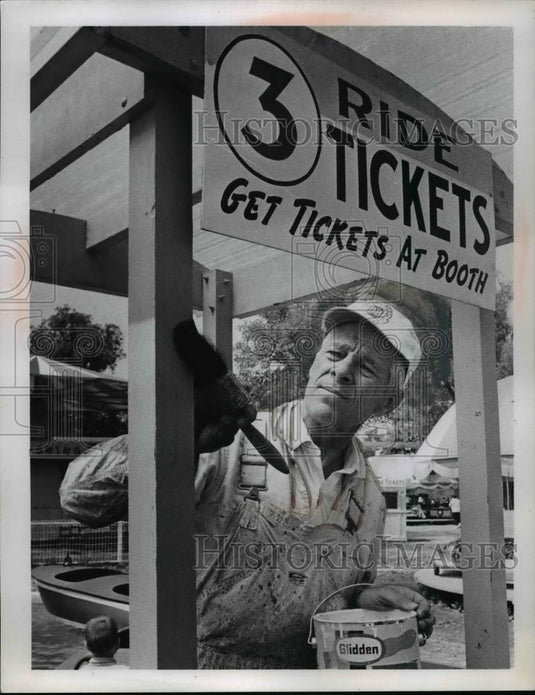 Press Photo Al Schneider Paints A Sign At Ticket Booth - nee85840 - Historic Images