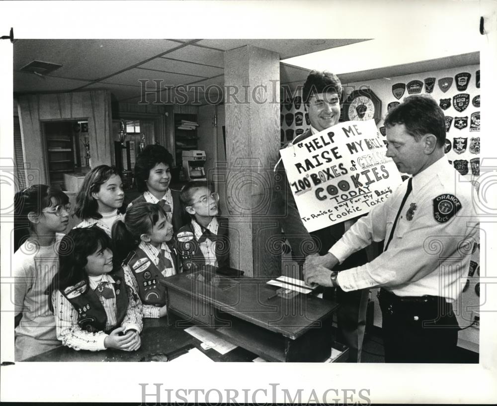 1988 Press Photo Members of the orange girl scout sell cookies - cva73130 - Historic Images