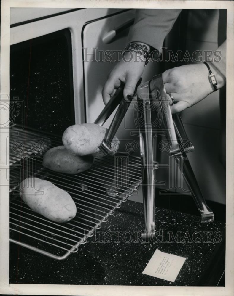 1947 Press Photo Getting the potatoes with Stainless Steel Tongs - nee87259 - Historic Images