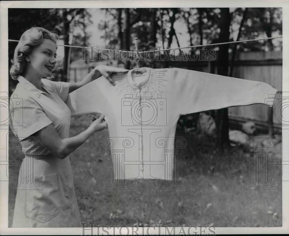 1953 Press Photo A woman hangs a sweater out to dry in the fresh air - nee84030 - Historic Images