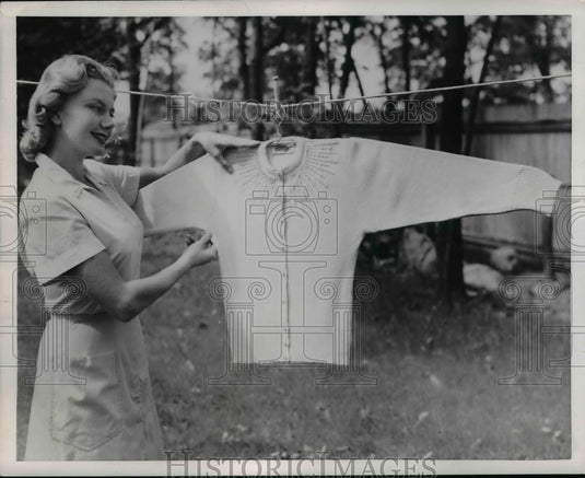 1953 Press Photo A woman hangs a sweater out to dry in the fresh air - nee84030 - Historic Images