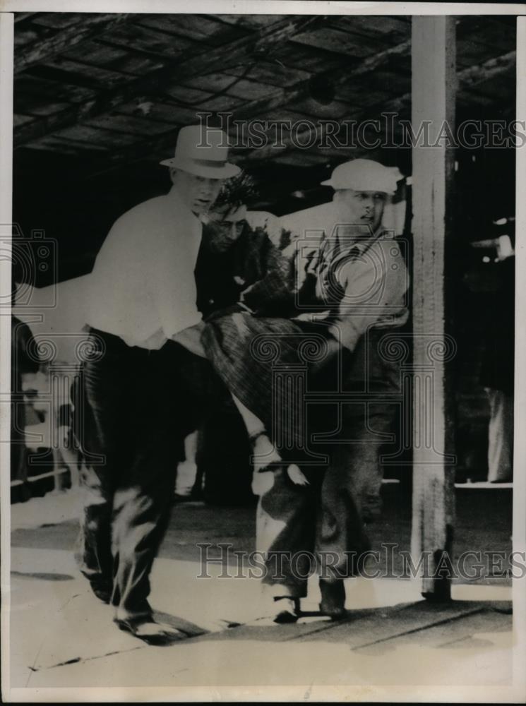 1937 Press Photo J.E. stone Being carried after being rescued from stormy water - Historic Images