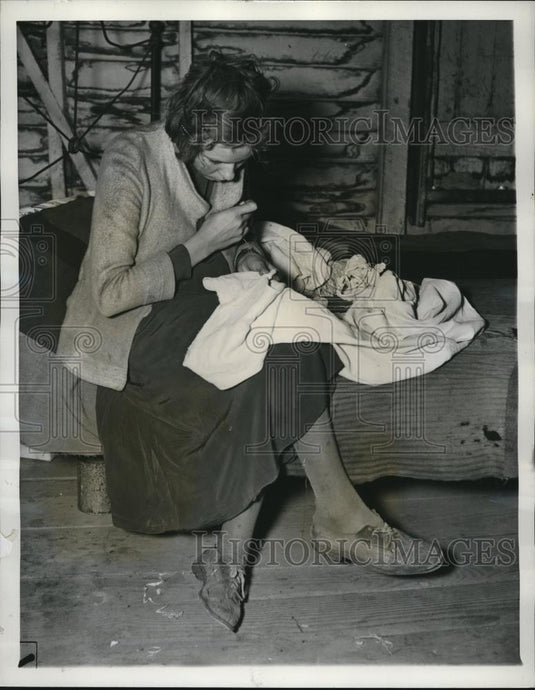 1937 Press Photo Charecropper wife patching clothes of husband - cva82771 - Historic Images