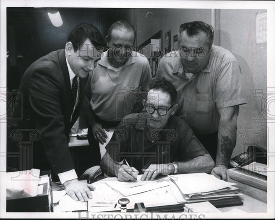 1968 Press Photo William McLumphy signs $560 check for PD Mine Disaster Fund - Historic Images