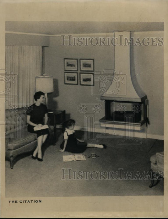 1960 Press Photo A woman & daughter sit by their homes livingroom fireplace - Historic Images