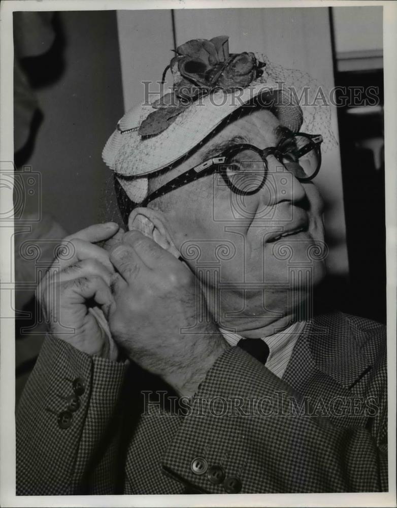 1954 Press Photo A man models an Easter bonnet for spring fashions - nee83794 - Historic Images