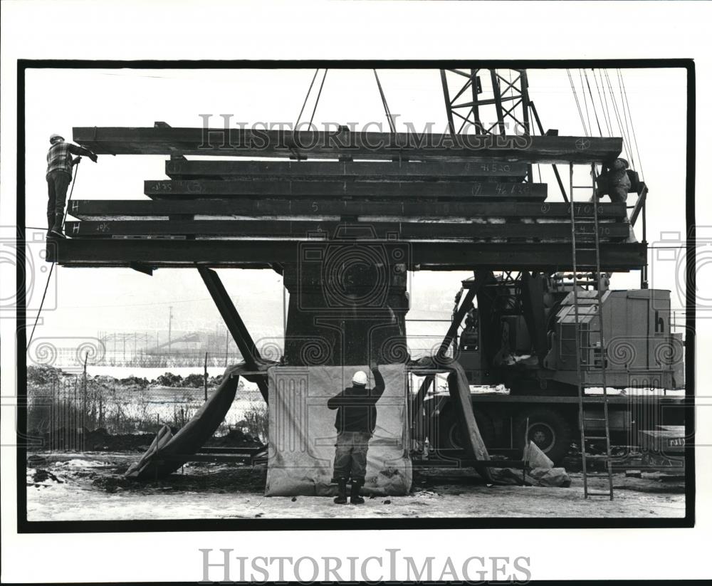 1986 Press Photo Lowering 32 ton beam on pier for Clark Ave Bridge construction - Historic Images