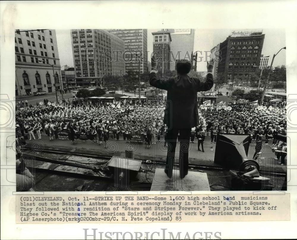 1983 Press Photo Band director Robert Flaming gives the down beat from a top the - Historic Images