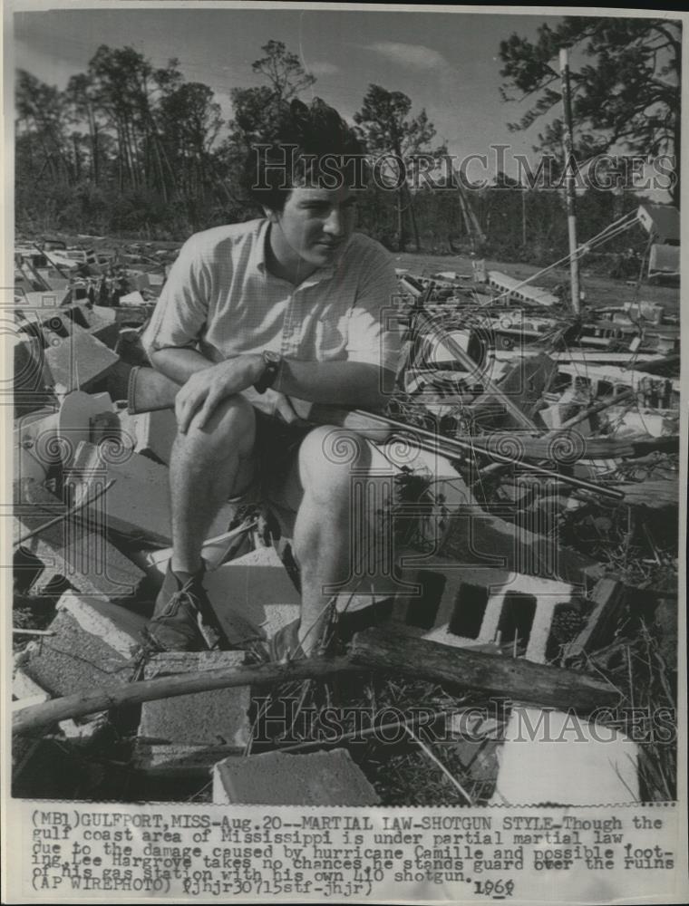 1969 Wire Photo Hargrove with shotgun stands guard on his gasstation by Camille - Historic Images