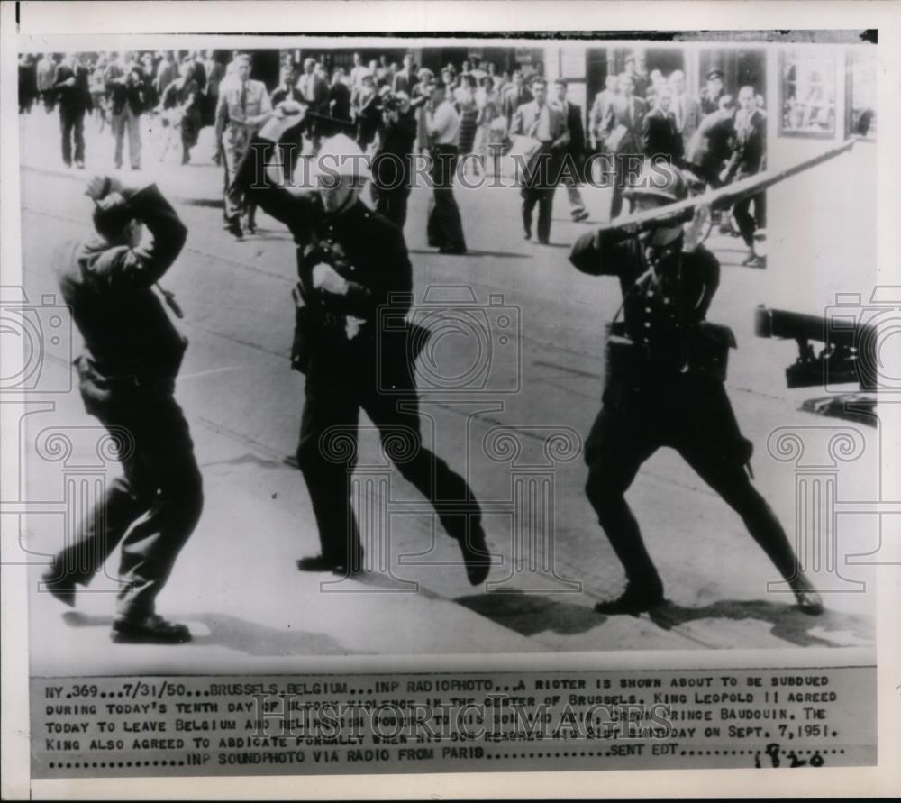 1950 Press Photo Rioter is shown about to be subdued in the center of Brussels - Historic Images