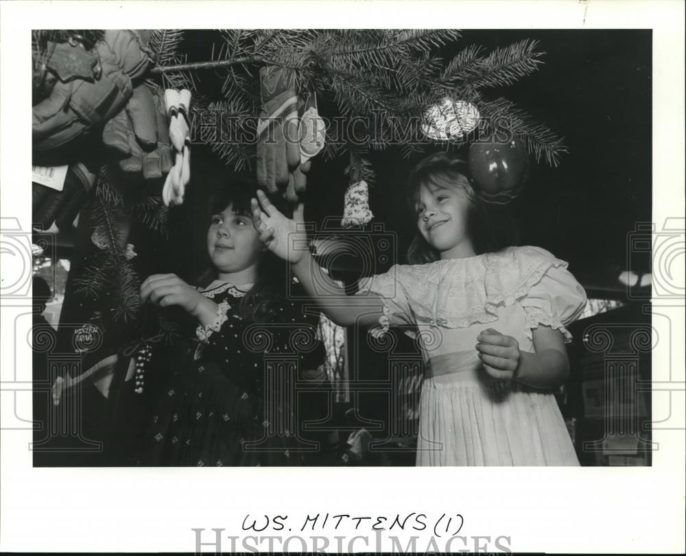 1993 Press Photo Children picking mittens off of a Christmas Tree - orb13318 - Historic Images