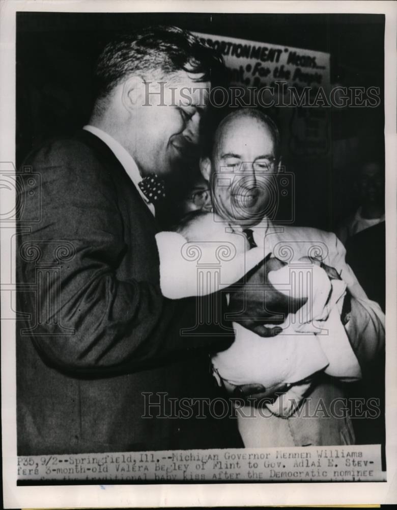 1952 Press Photo Gov Mennen Williams offers a baby to Gov.Adlai Stevenson - Historic Images