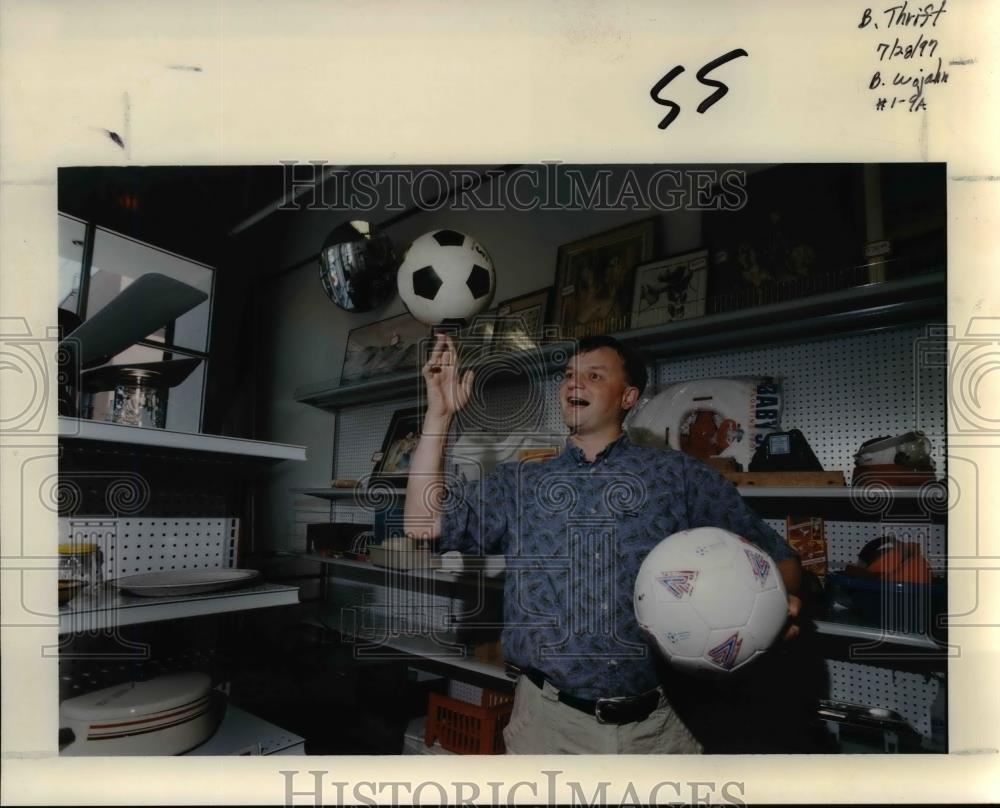 1997 Press Photo Guy in a Thrift Shop, plays w/ a ball - orb54615 - Historic Images