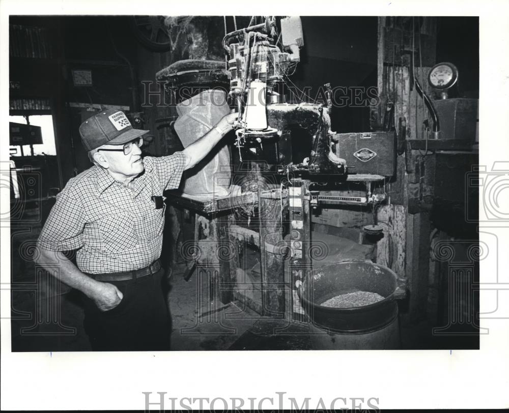 1982 Press Photo Boucher shown grain sacker and bag sewer - orb09180 - Historic Images