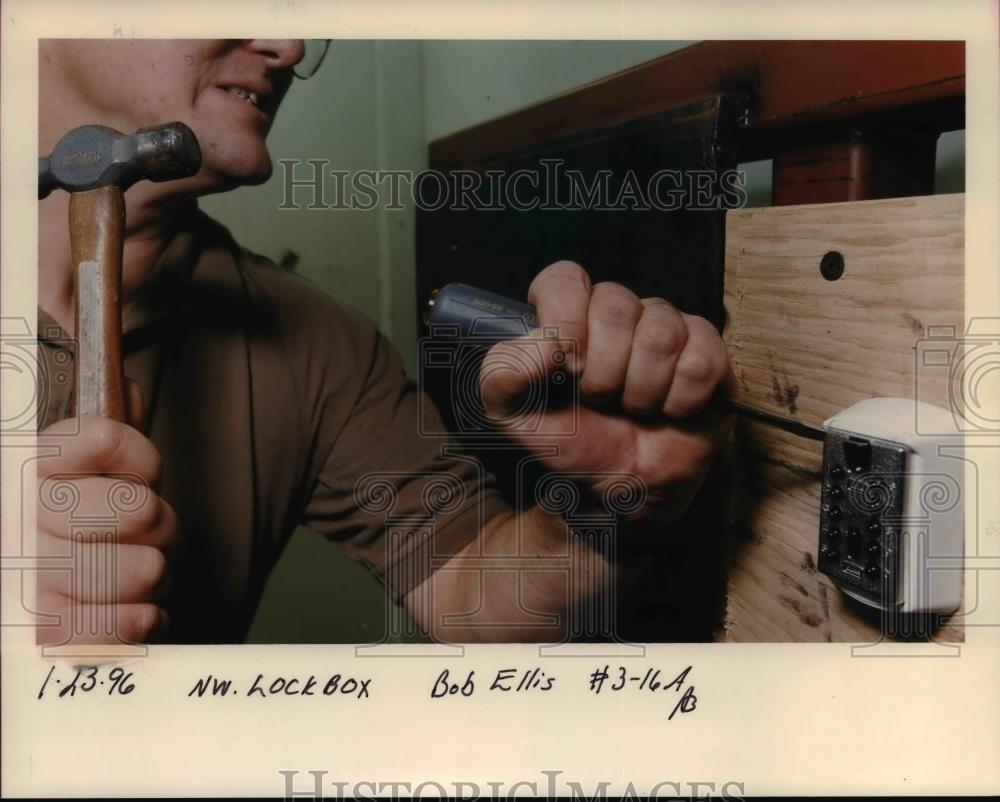 1996 Press Photo A man trying to open the lock box - orb22036 - Historic Images