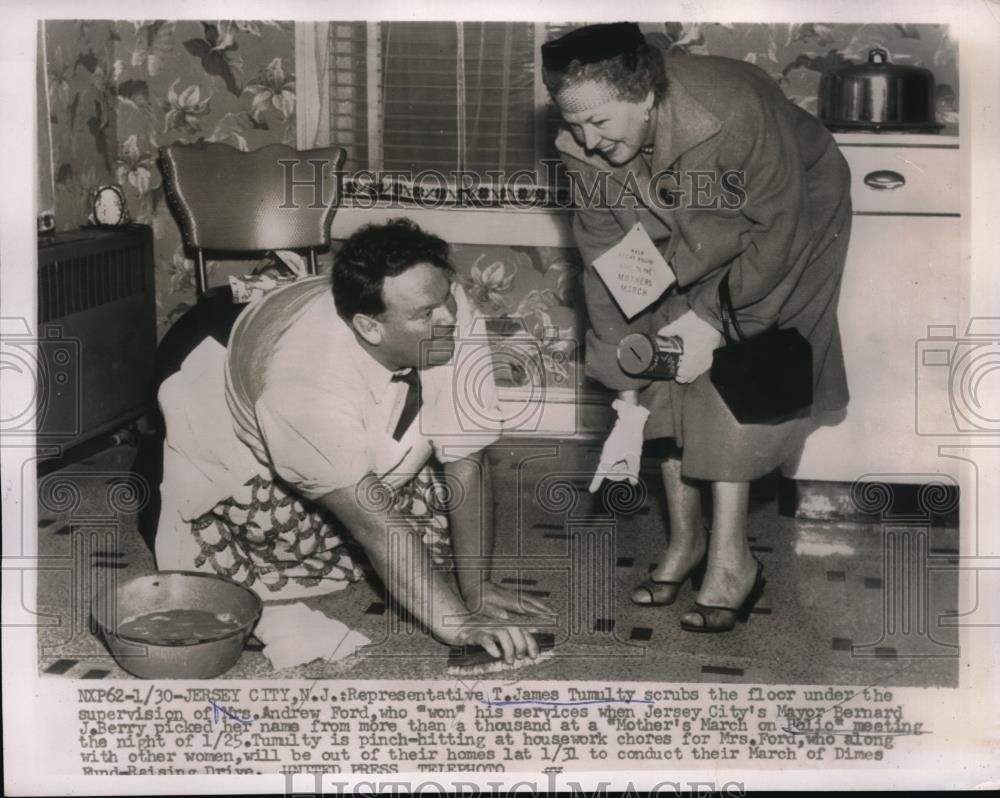 1956 Press Photo Rep.T.James Tumulty scrubs the floor of Mrs Andrew Ford - Historic Images