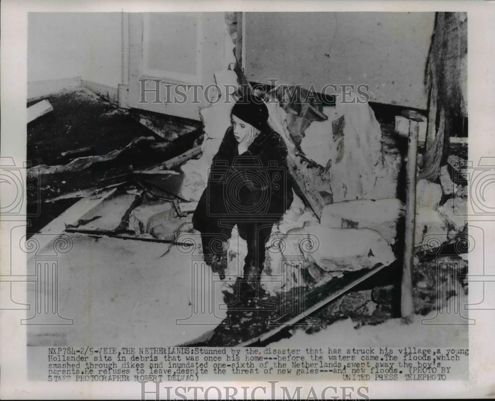 1953 Press Photo Young Holland boy sits in debris of his home - nee92637 - Historic Images