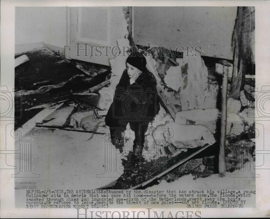 1953 Press Photo Young Holland boy sits in debris of his home - nee92637 - Historic Images