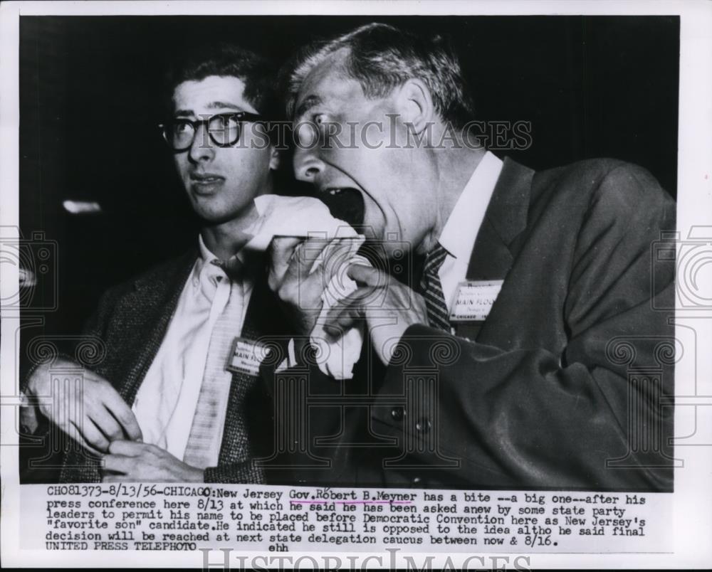 1956 Press Photo Gov. Robert B Meyner bite his bread during press Conference - Historic Images