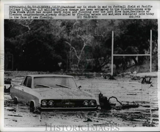 1969 Press Photo Abandoned car stuck in mud at football field in Pacific College - Historic Images