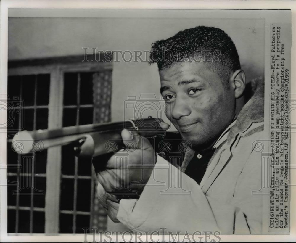 1959 Press Photo Floyd Patterson holds an air rifle at his training camp - Historic Images