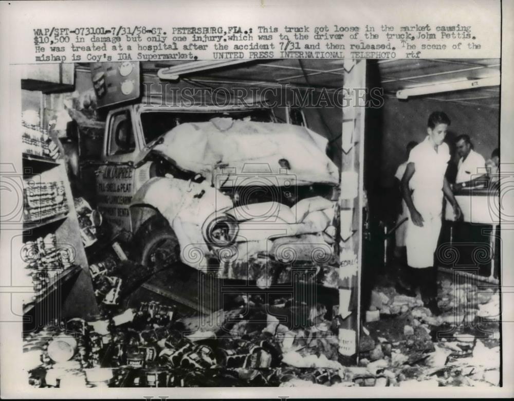 1958 Press Photo John Pettis taken to hospital after crashing his truck - Historic Images