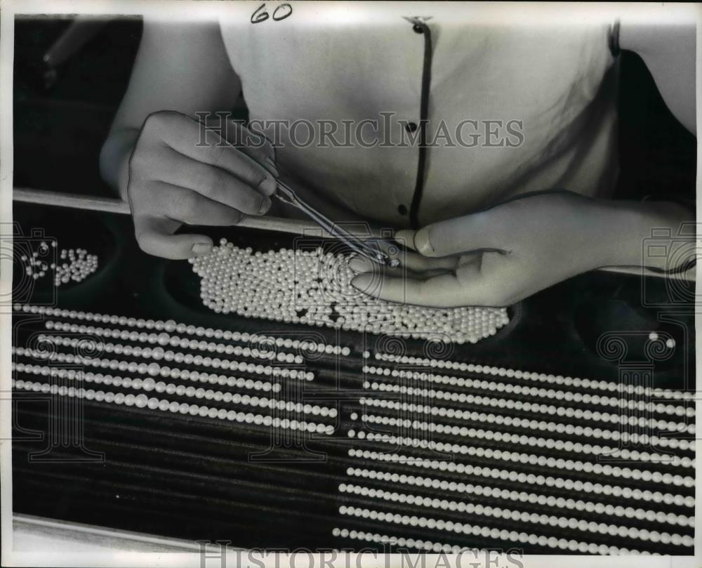 1963 Press Photo Girl Sorting Pearls by Size for Necklaces - nef01594 - Historic Images