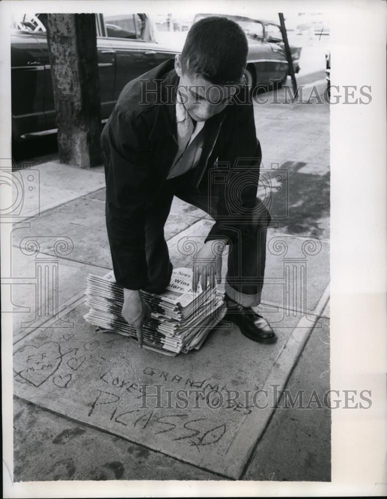 1957 Press Photo Newsboy Carl Kirby Points to Picasso Sidewalk Concrete Etching - Historic Images