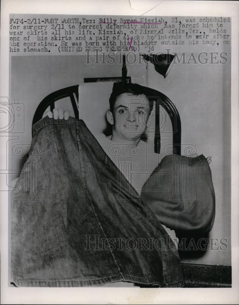 1958 Press Photo Billy Byron Kizziah holds skirt & pair of pants - nef01299 - Historic Images