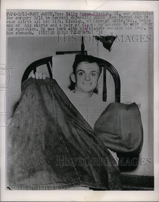 1958 Press Photo Billy Byron Kizziah holds skirt & pair of pants - nef01299 - Historic Images