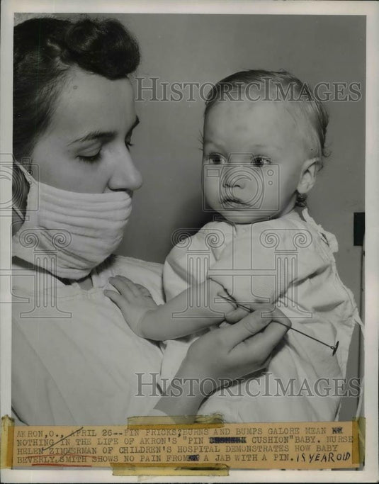 1948 Press Photo Helen Zimmerman demonstrate no pain from a jab with a pin - Historic Images