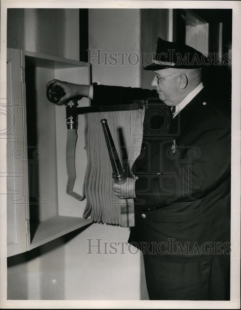 1950 Press Photo Captain Willis McClure inspects standpipe outlet - nef00878 - Historic Images