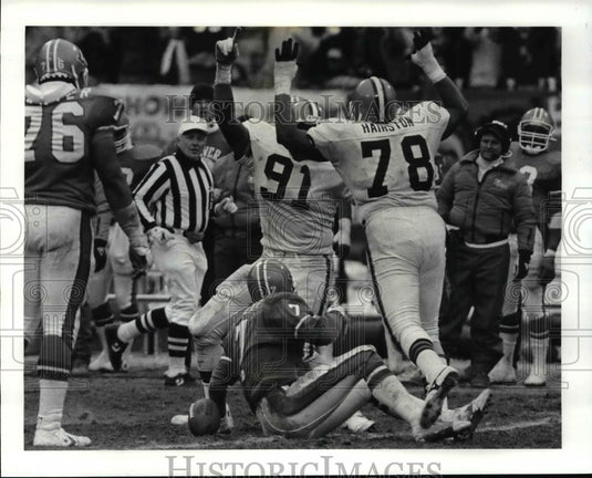 Press Photo Sack Elway lies on the ground after being sacked by Sam Clancy