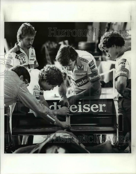 1984 Press Photo Mario Andretti's Crew Adjusts the Rear Wing in the Garage Area - Historic Images