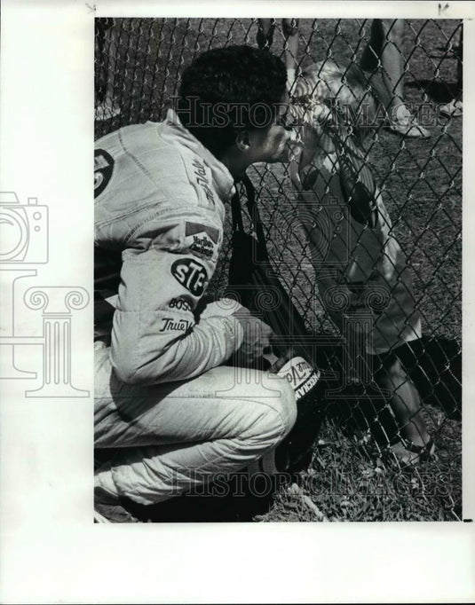 1987 Press Photo Car racer Roberto Guerrero kisses his son, Marco - cvb69970 - Historic Images